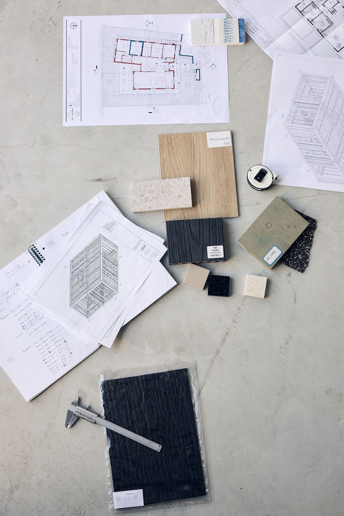 Drawings with material samples laid across them