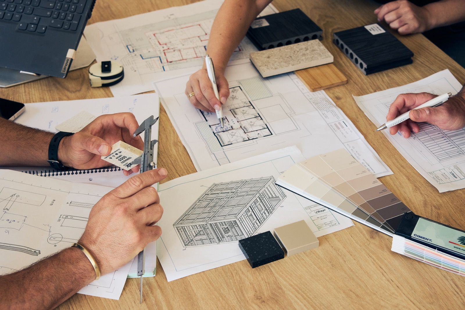 Drawings, finish schedules and material samples reviewed together on a project table